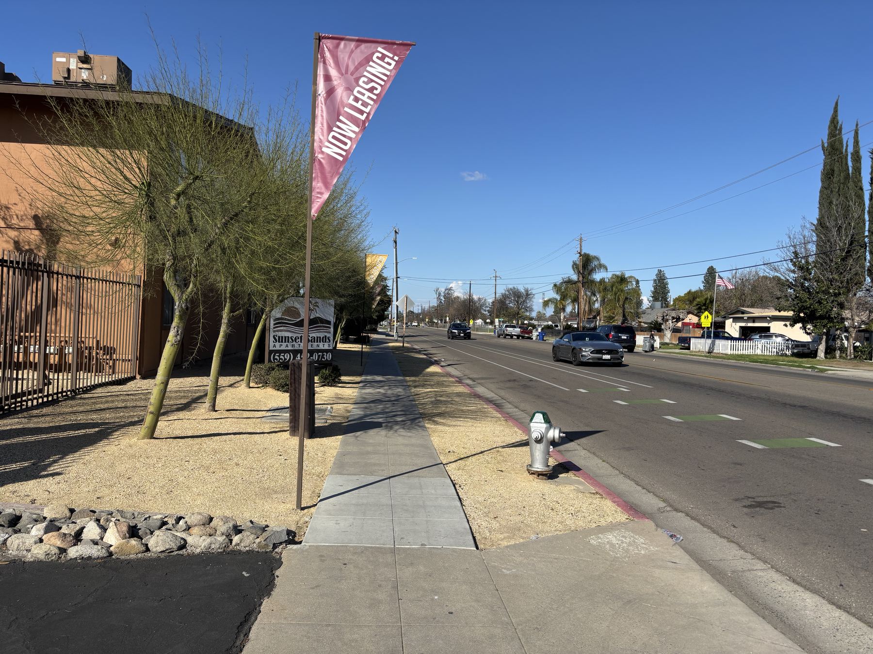 Sunset Sands Apartments street view and sign