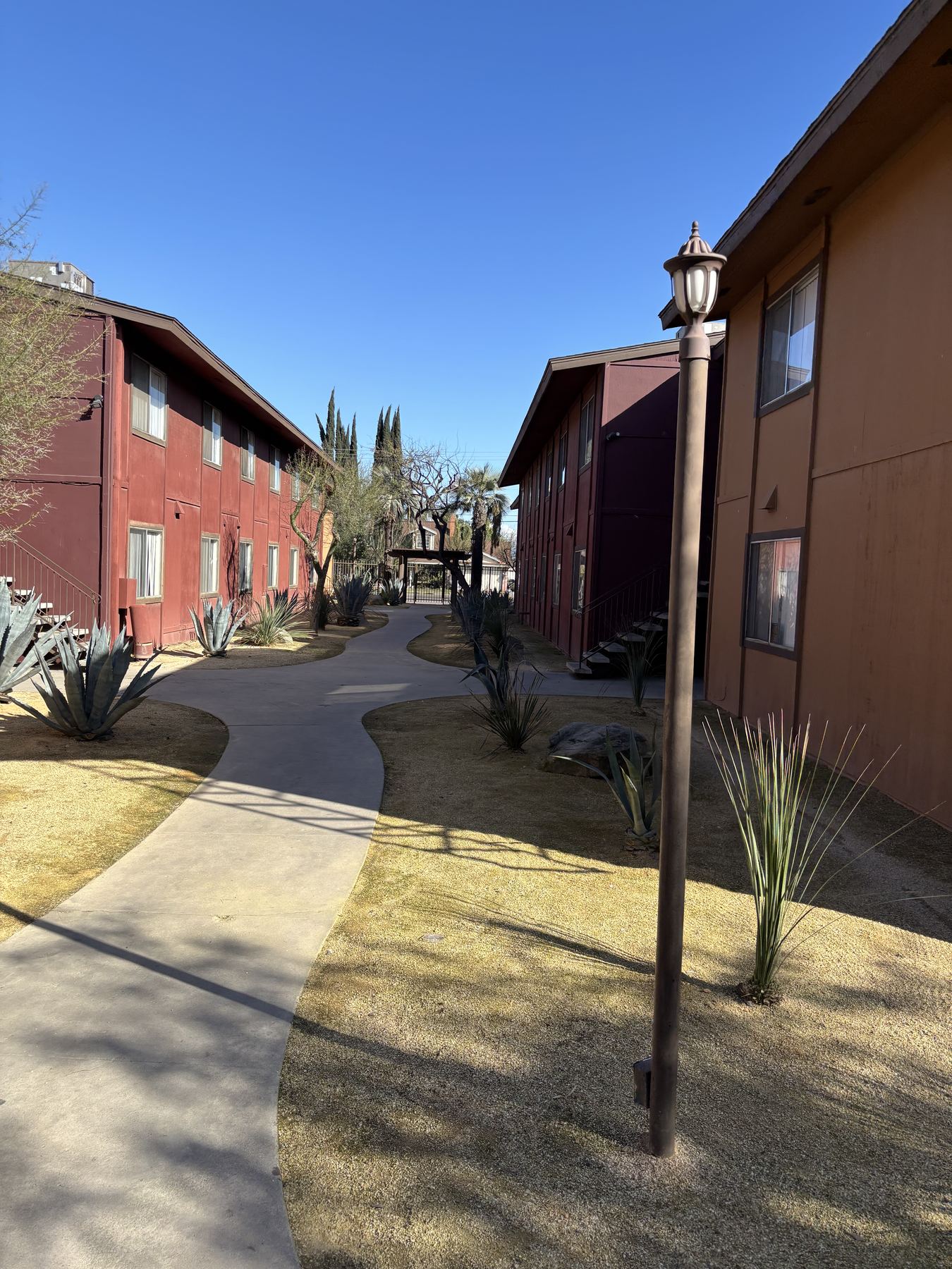 Walkway between the Sunset Sands buildings, desert landscaping